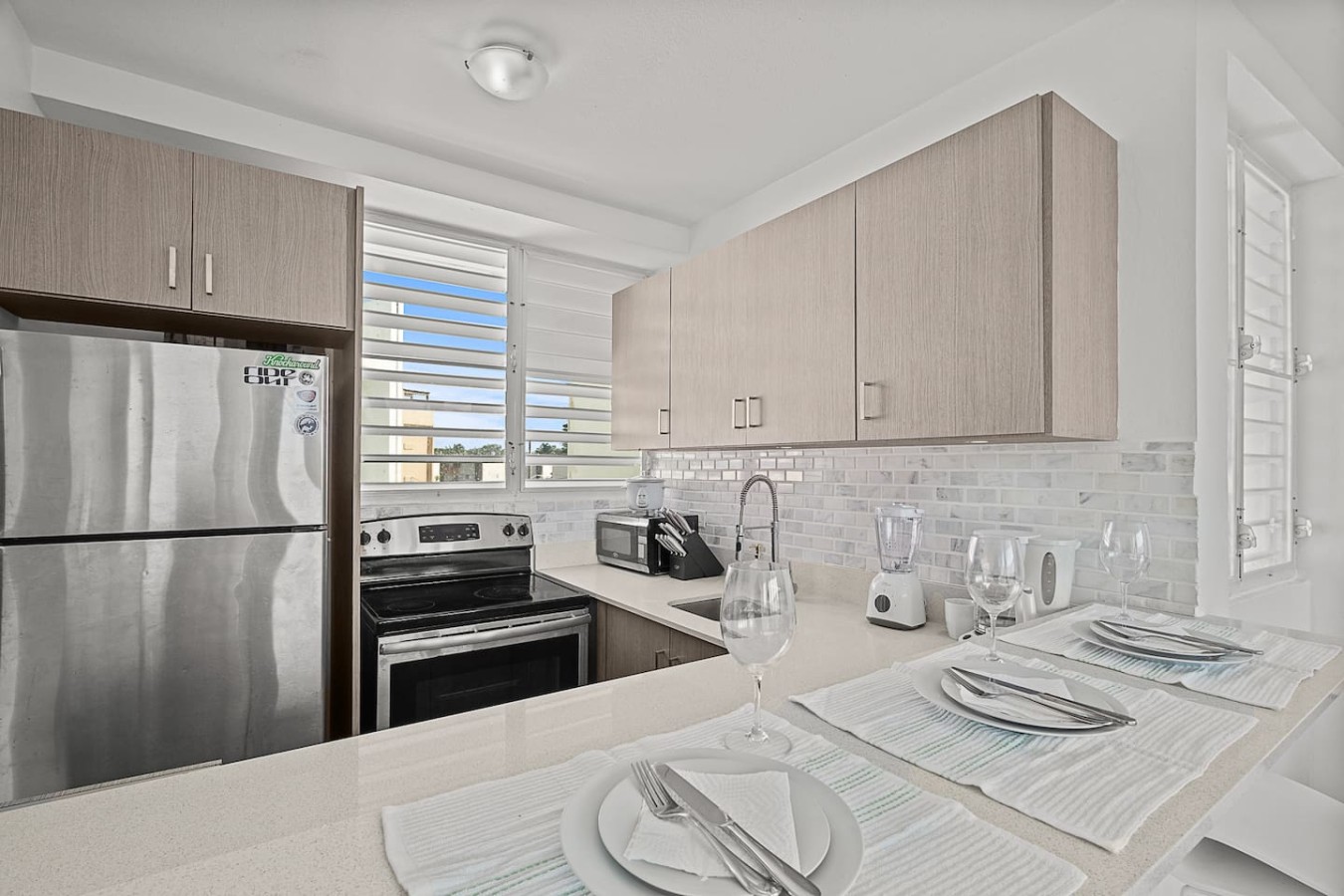 Kitchen with a stove top oven and a refrigerator — Ocean Park 2BR · Steps to Beach & Dining, Santurce