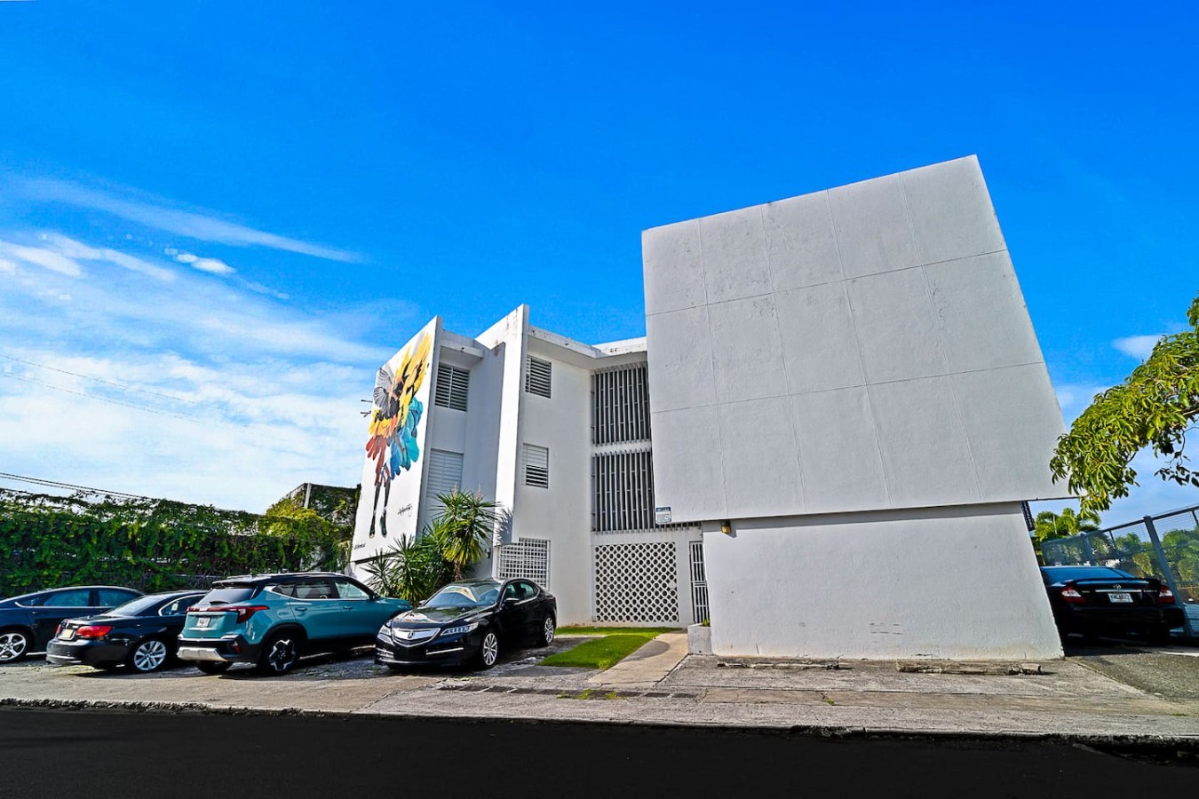 White apartment building and its parking lot — Ocean Park 2BR · Steps to Beach & Dining, Santurce