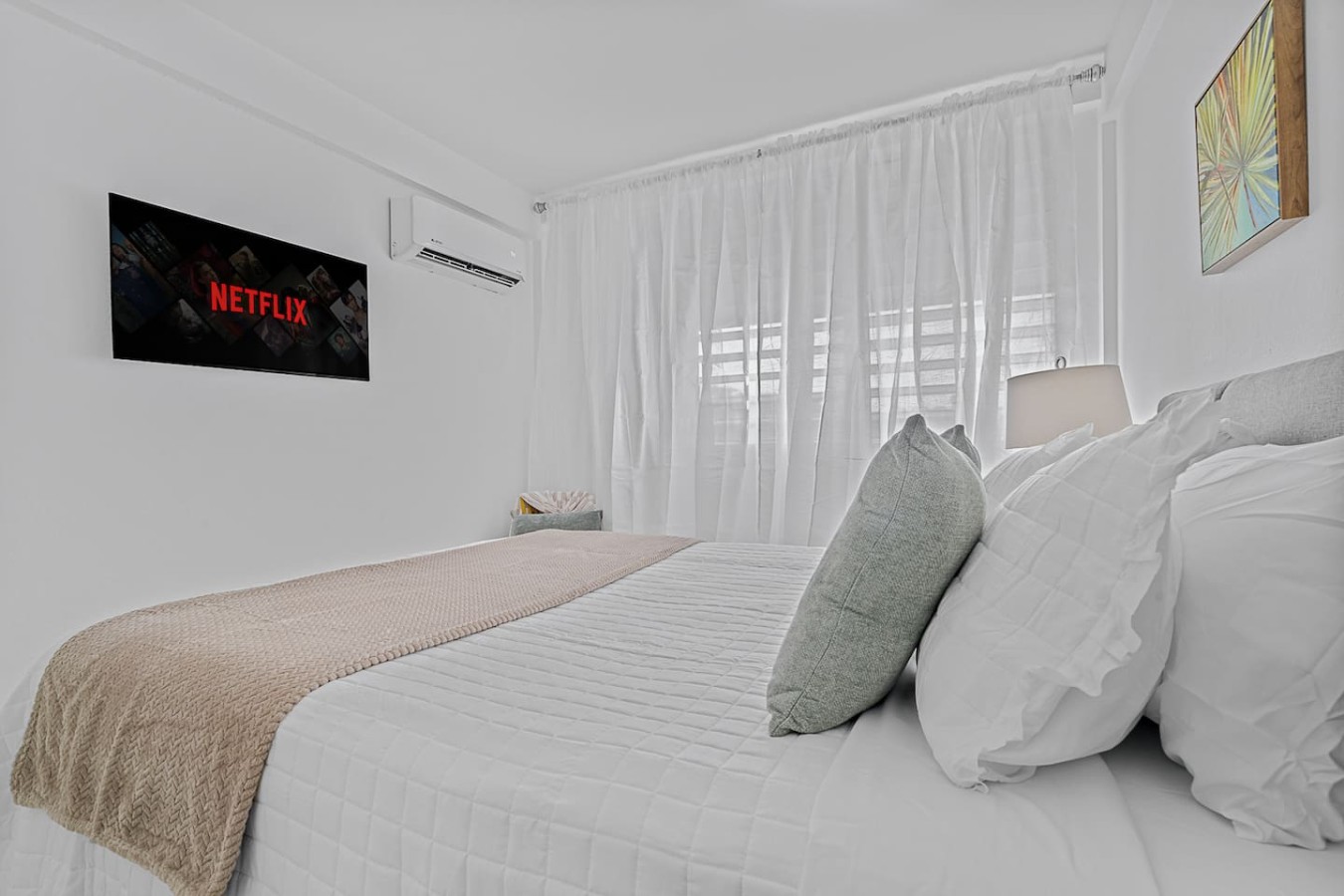 Bedroom with a white bedspread and a red pillow — Ocean Park 2BR · Steps to Beach & Dining, Santurce