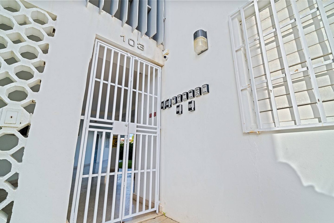 Building's entrance behind a white iron gate — Ocean Park 2BR · Steps to Beach & Dining, Santurce