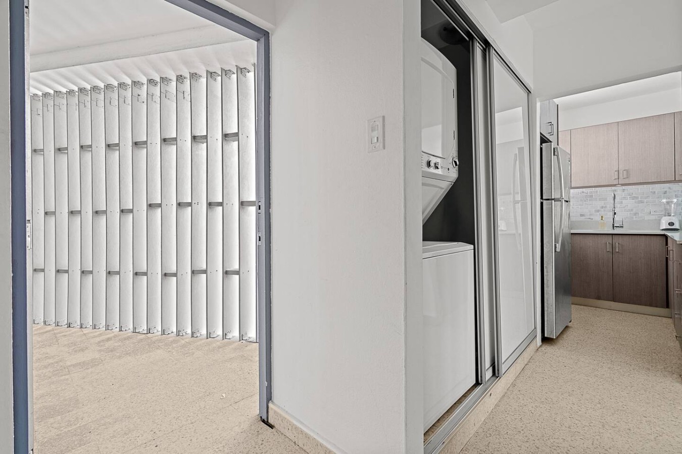 Laundry closet with a stacked washer and dryer — Ocean Park 2BR · Steps to Beach & Dining, Santurce
