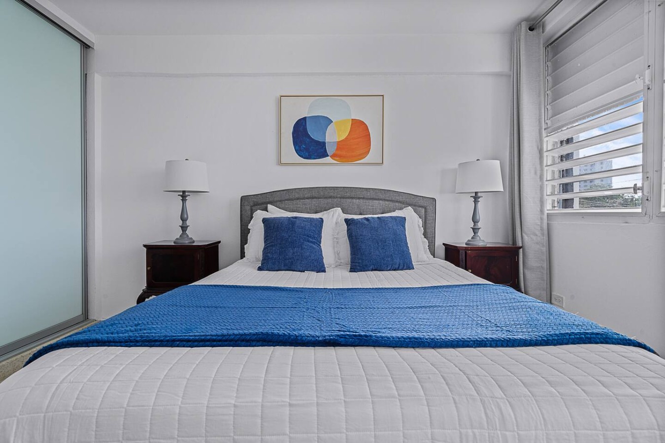 Bedroom with a blue bedspread and blue pillows — Ocean Park 2BR · Steps to Beach & Dining, Santurce