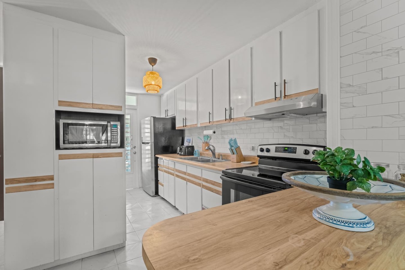 Kitchen with white cabinets and a stainless steel stove — Beachside Villa Dorado Pool Beach Access