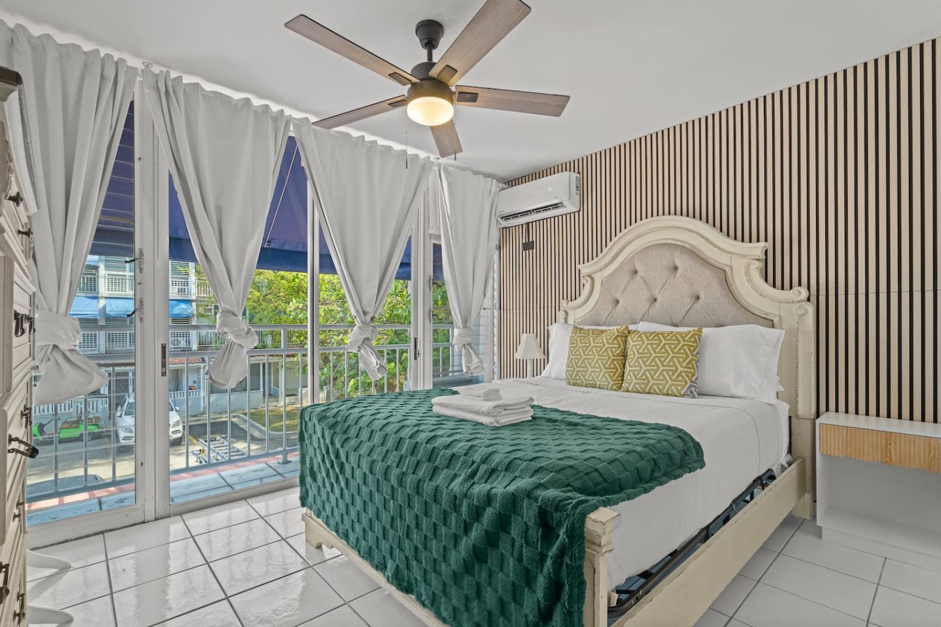 Bedroom with a large bed, green bedspread, and white pillows — Beachside Villa Dorado Pool Beach Access, Dorado