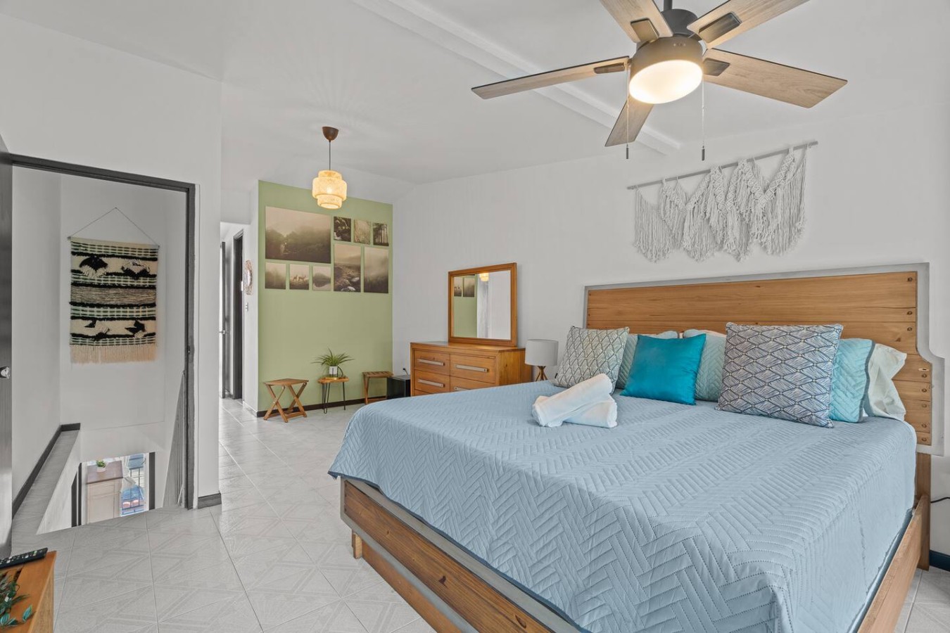 Bedroom with a blue bedspread and a fan hanging from the ceiling — Beachside Villa Dorado Pool Beach Access, Dorado