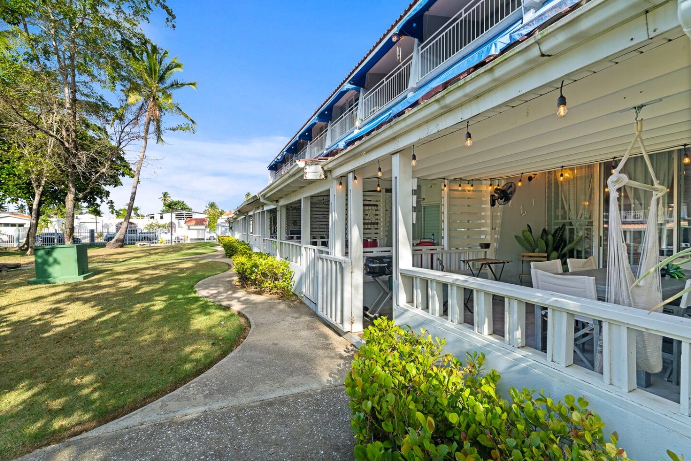 White building with blue trim and a balcony overlooking the ocean — Beachside Villa Dorado Pool Beach Access, Dorado