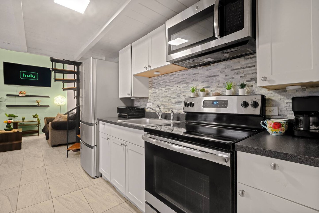 Kitchen with a stove top oven and a microwave above it — Historic Loft in the Heart of Old San Juan, Old San Juan