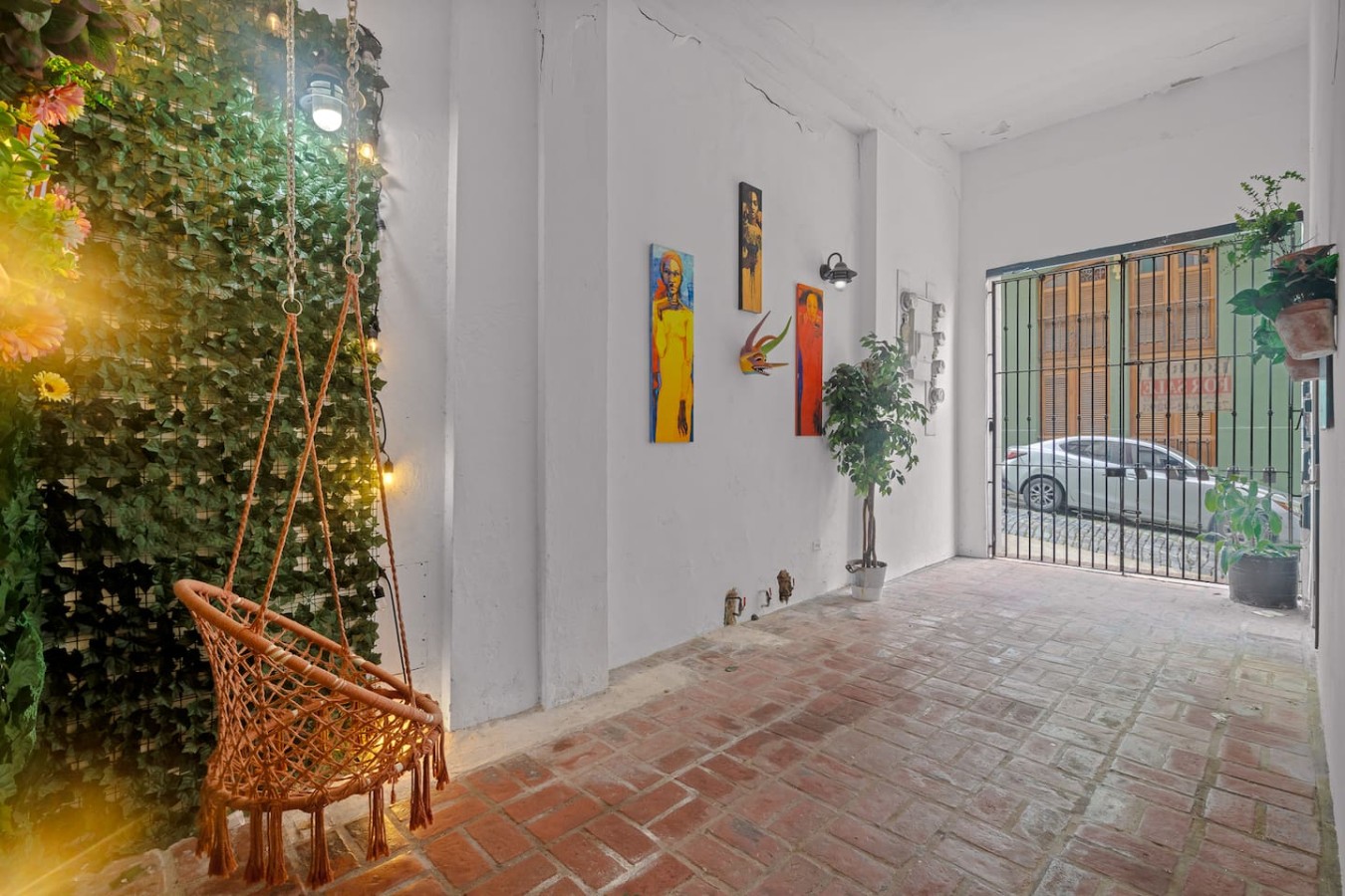 White room with a painting on the wall and a potted plant — Historic Loft in the Heart of Old San Juan, Old San Juan