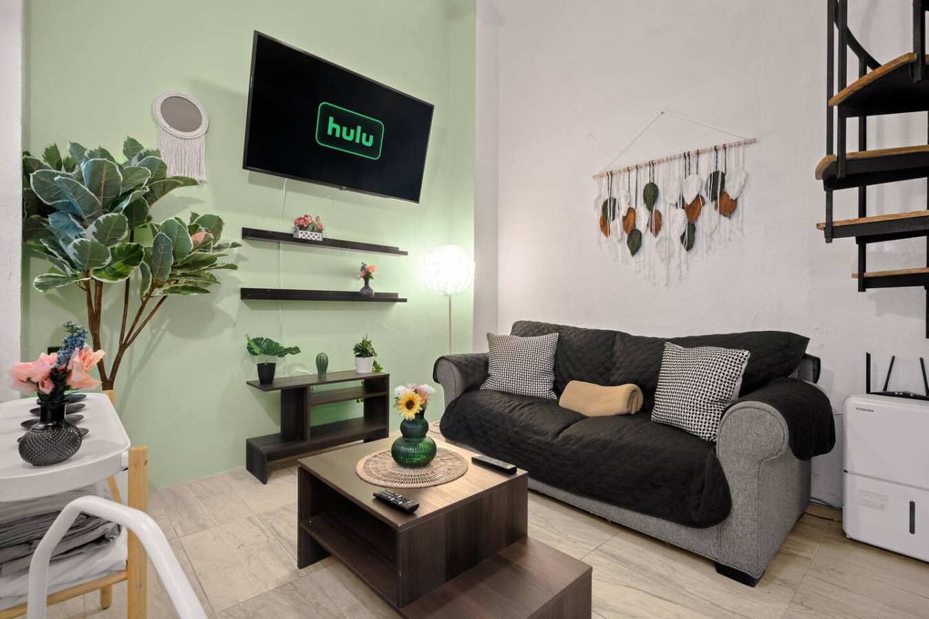 Living room with a black couch and a flat screen TV — Historic Loft in the Heart of Old San Juan, Old San Juan