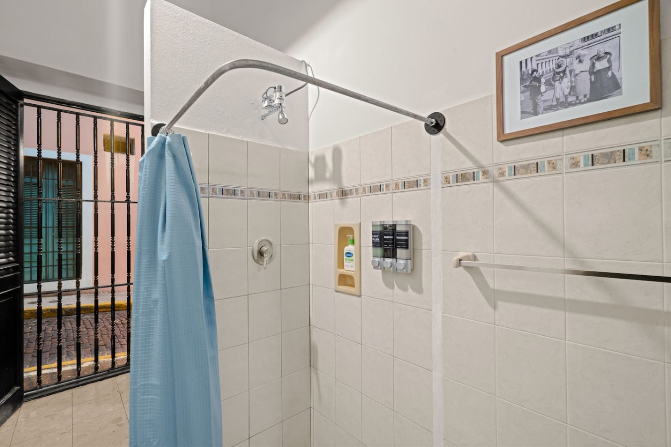 Shower with a blue shower curtain and a white tile wall — 3B Imperial, Old San Juan