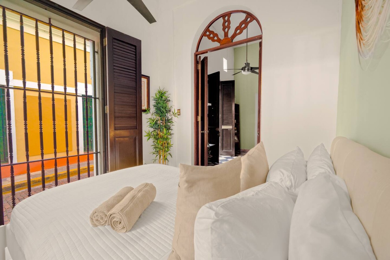 Bedroom with a bed, a potted plant, and a towel on the bed — 3B Imperial, Old San Juan