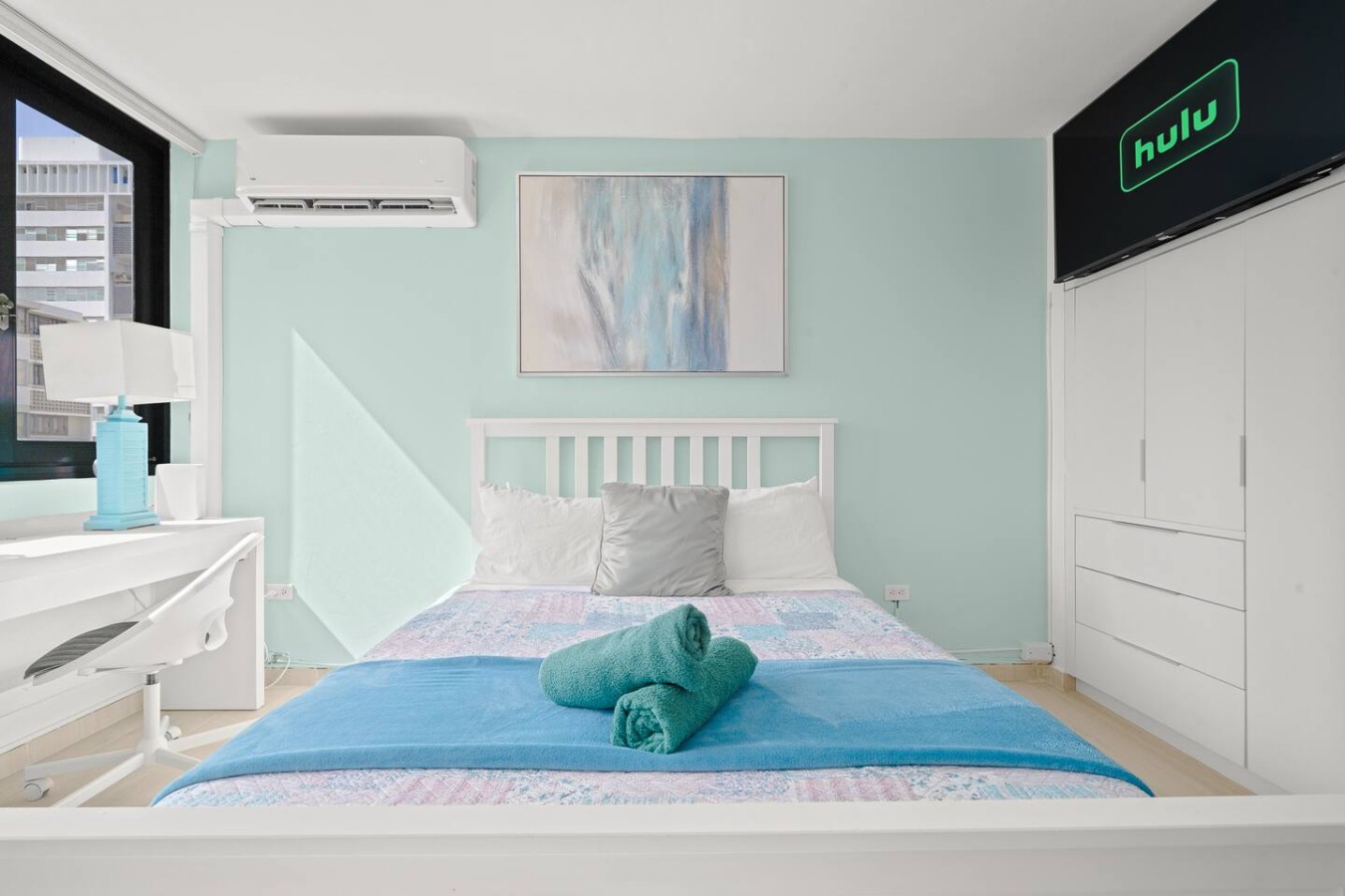 Bedroom with a blue bedspread and a white headboard — Casa Celeste | Sunlit Tropical Stay in Condado, Santurce