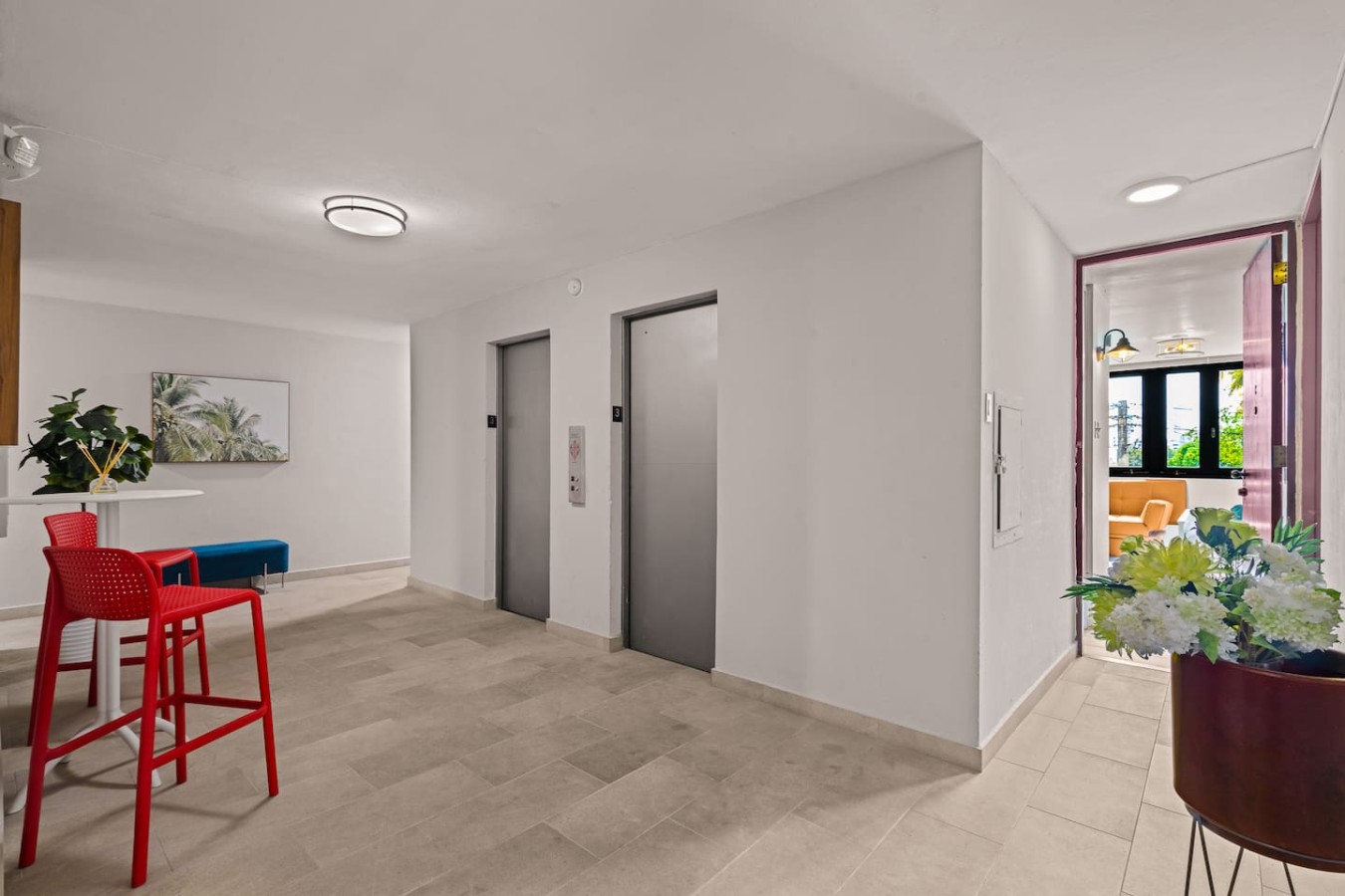 Building's hallway with elevators and the apartment door — Casa Celeste | Sunlit Tropical Stay in Condado, Santurce