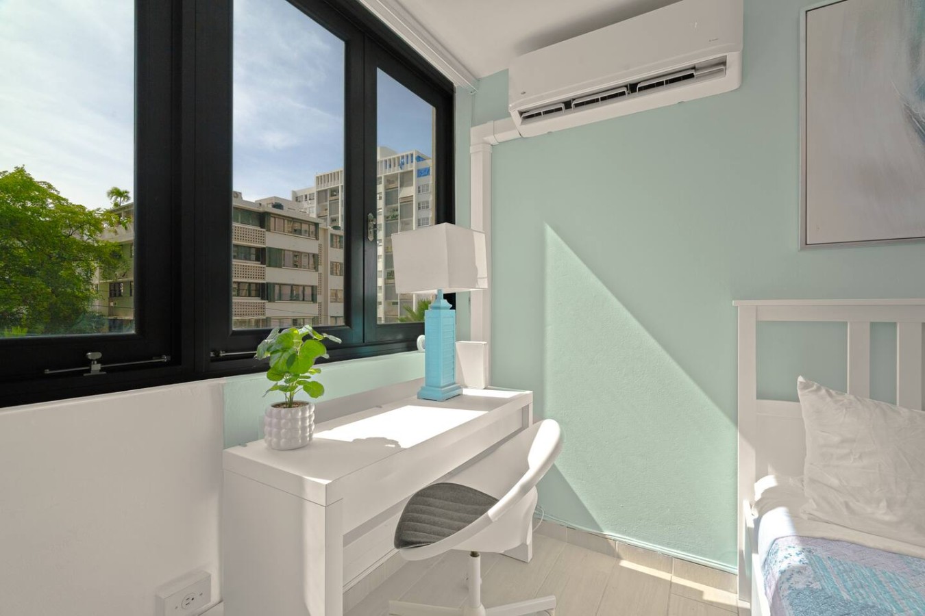 Bedroom desk and chair by the windows — Casa Celeste | Sunlit Tropical Stay in Condado, Santurce