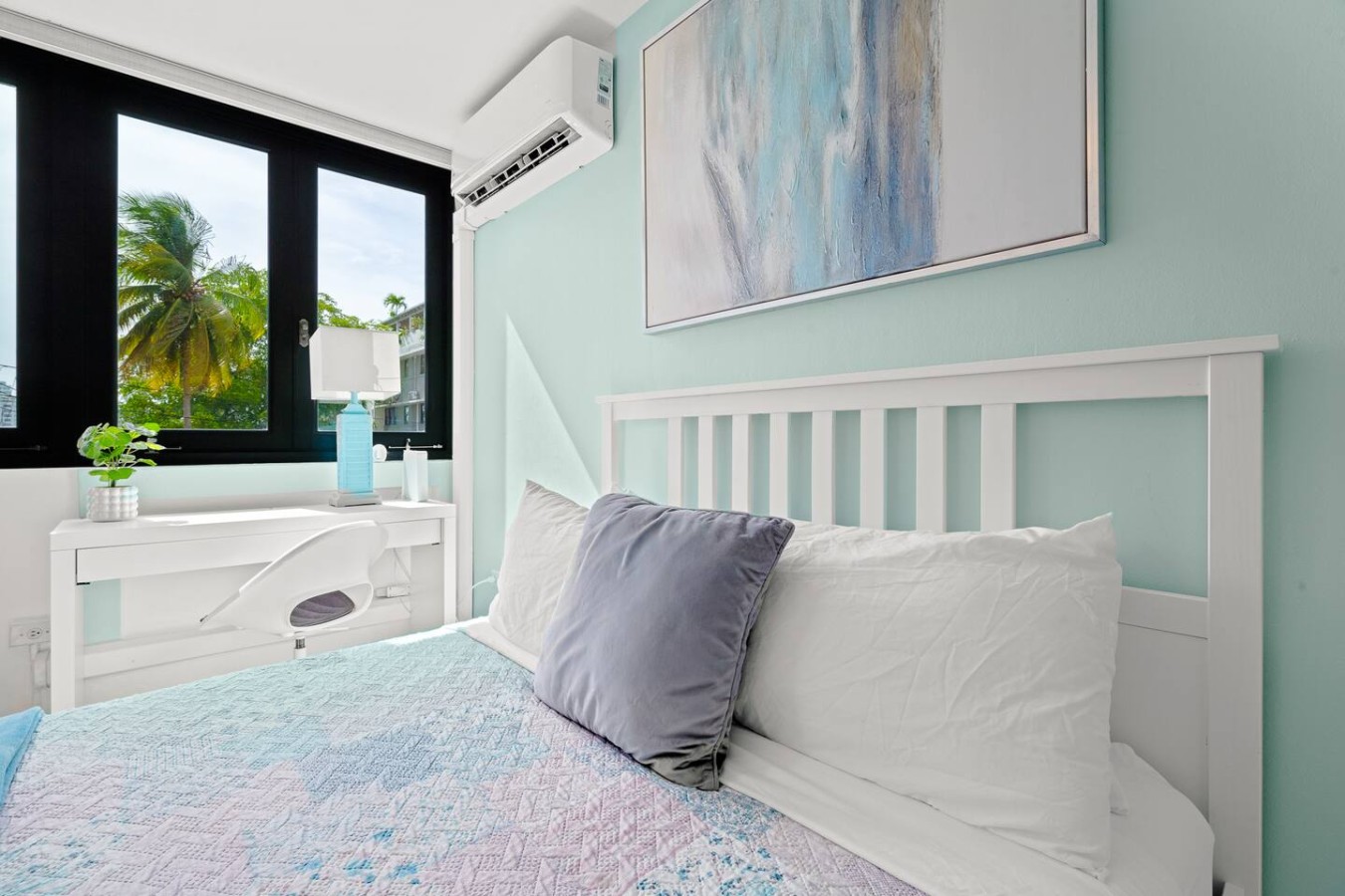 Bedroom with a blue bedspread and a view of the ocean (bedroom 2) — Casa Celeste | Sunlit Tropical Stay in Condado, Santurce