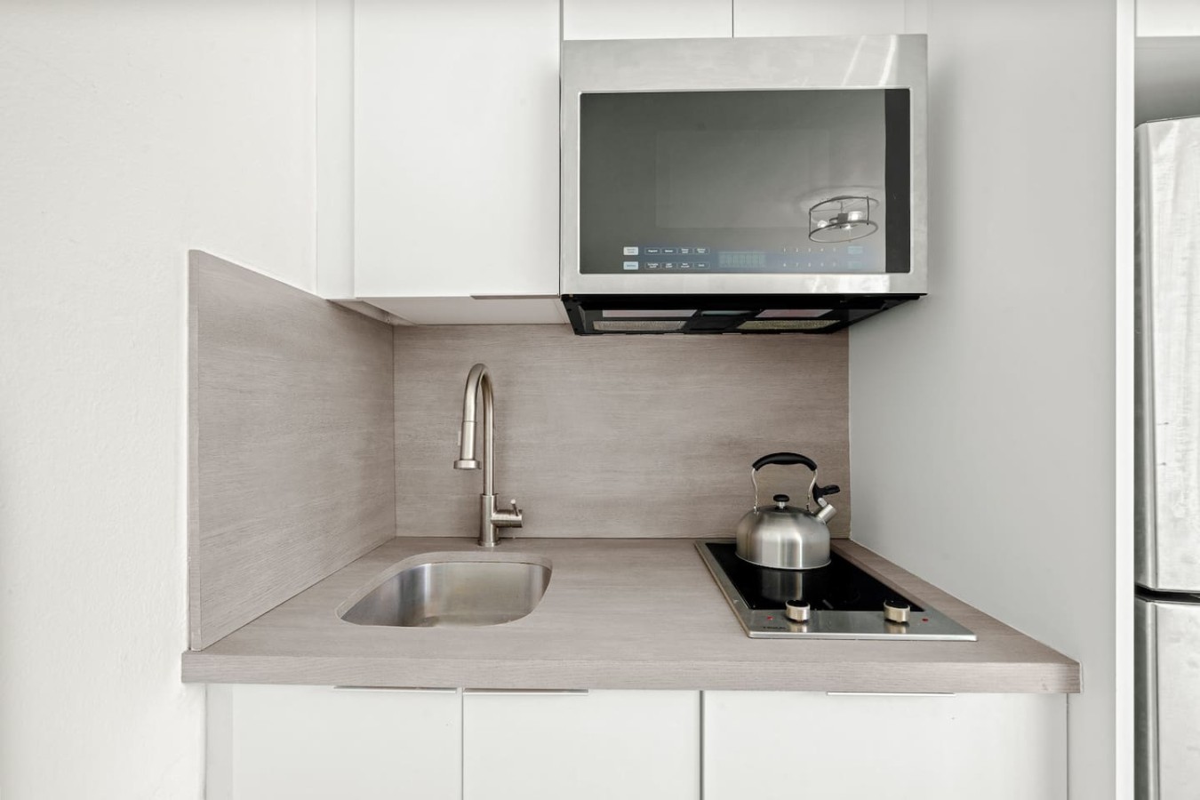 Kitchen with a sink, stove, and microwave — Casa Celeste | Sunlit Tropical Stay in Condado, Santurce