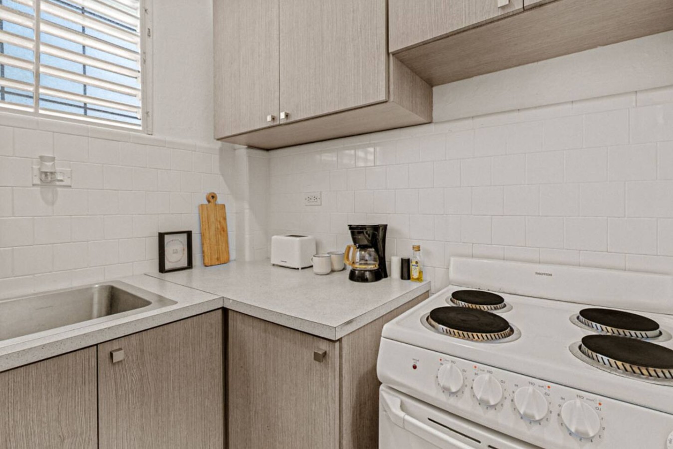 Kitchen with a white stove and a wooden cutting board — Virelia | Colorful San Juan Escape for Four, Santurce