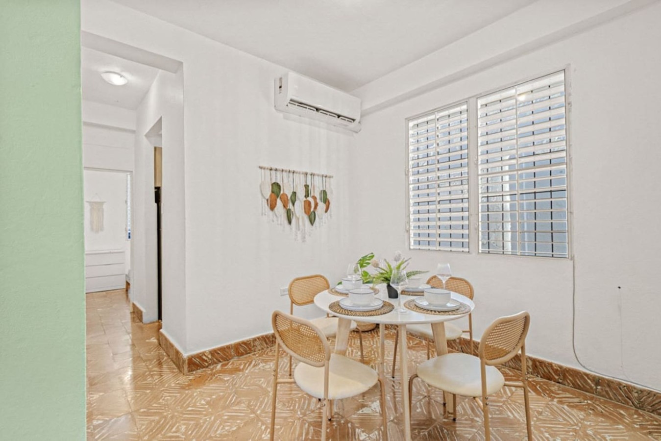 Dining room table with chairs and a potted plant on the table — Virelia | Colorful San Juan Escape for Four, Santurce