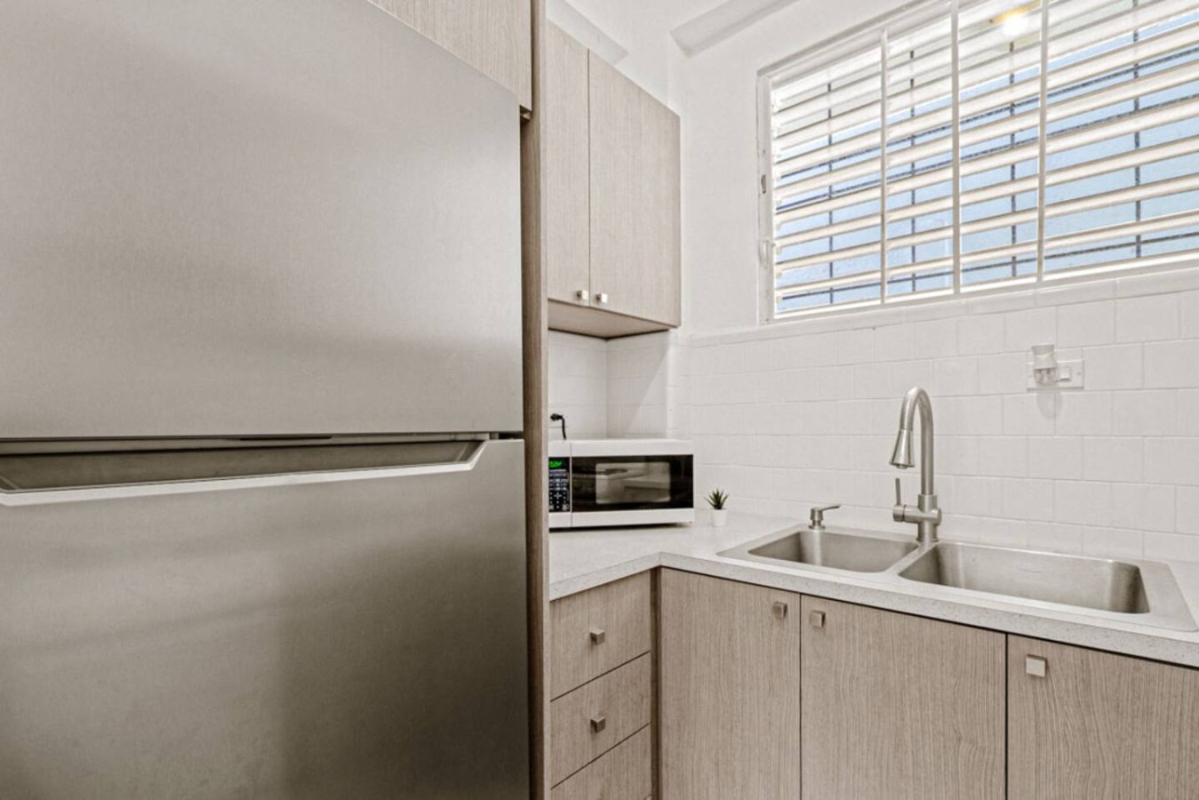 Kitchen with a refrigerator, microwave, and sink — Virelia | Colorful San Juan Escape for Four, Santurce