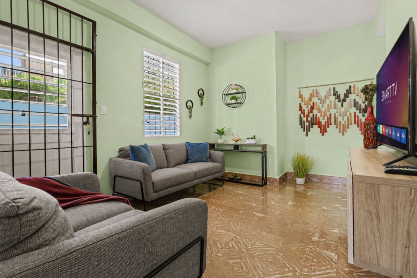 Living room with a grey couch and a green wall — Virelia | Colorful San Juan Escape for Four, Santurce