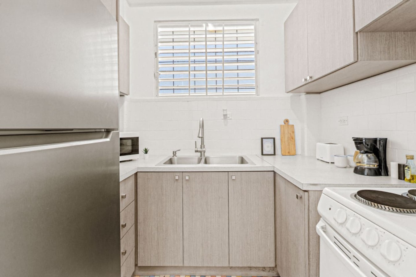 Kitchen with a sink and a refrigerator — Virelia | Colorful San Juan Escape for Four, Santurce