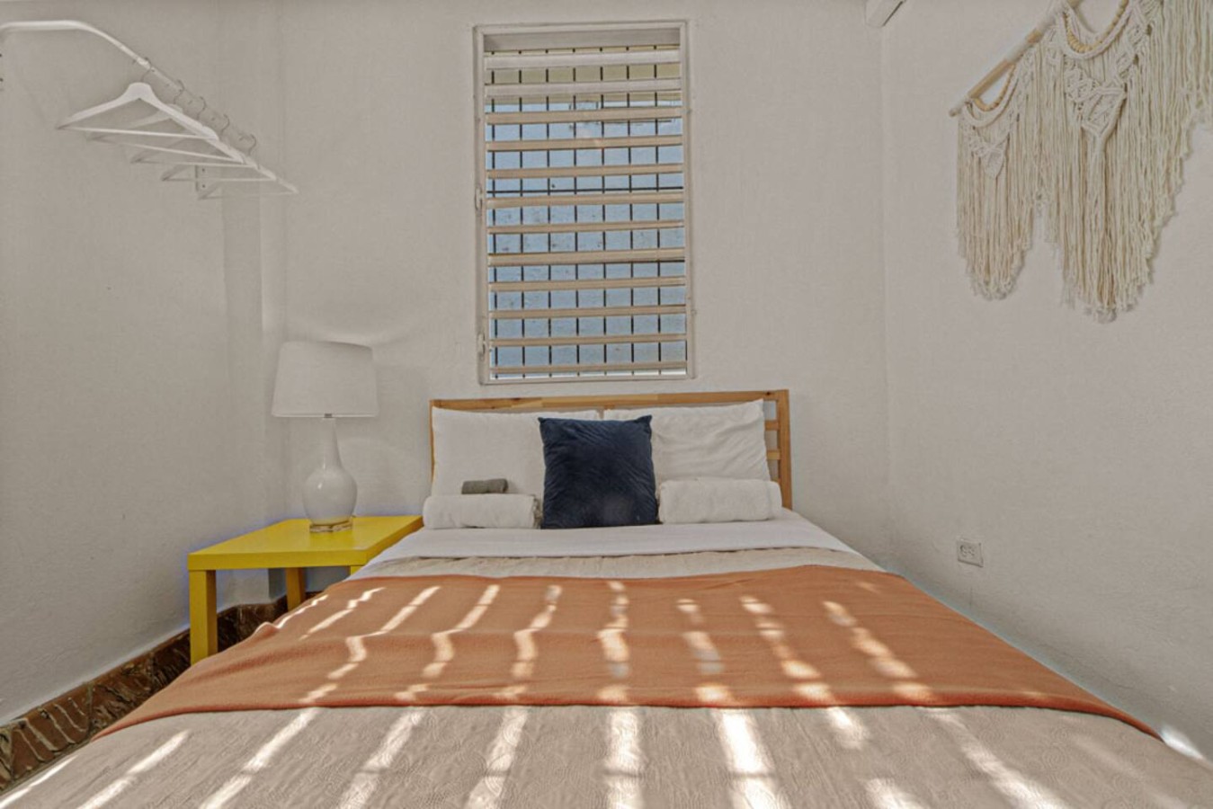 Bedroom with a bed and a lamp — Virelia | Colorful San Juan Escape for Four, Santurce