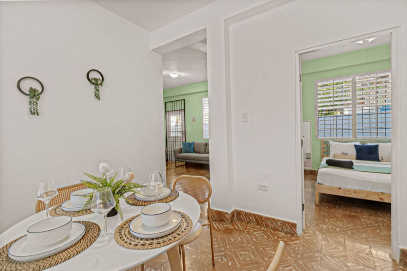 Dining room table with chairs and a vase of flowers on it — Virelia | Colorful San Juan Escape for Four, Santurce