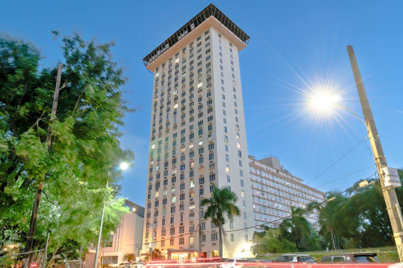 Tall white building with a balcony on the top floor — T-Mobile District San Juan Next to Beach, San Juan