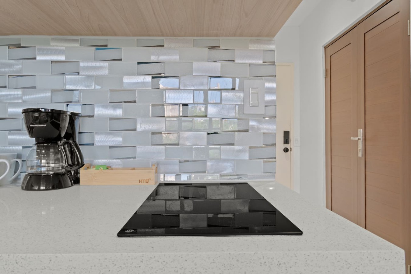 Kitchen cooktop and coffee maker by the front door — T-Mobile District San Juan Next to Beach
