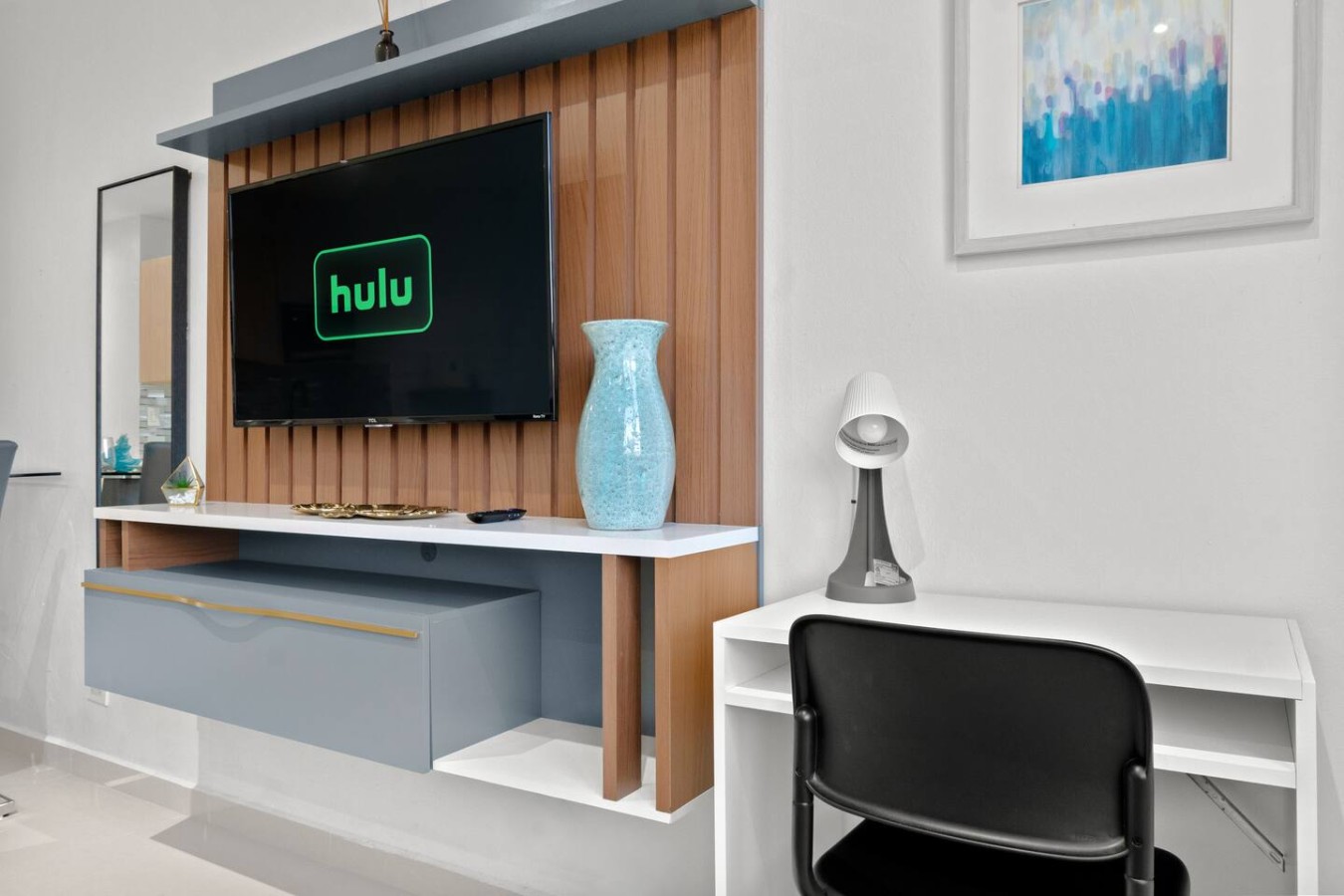 Living room with a flat screen TV and a vase — T-Mobile District San Juan Next to Beach, San Juan