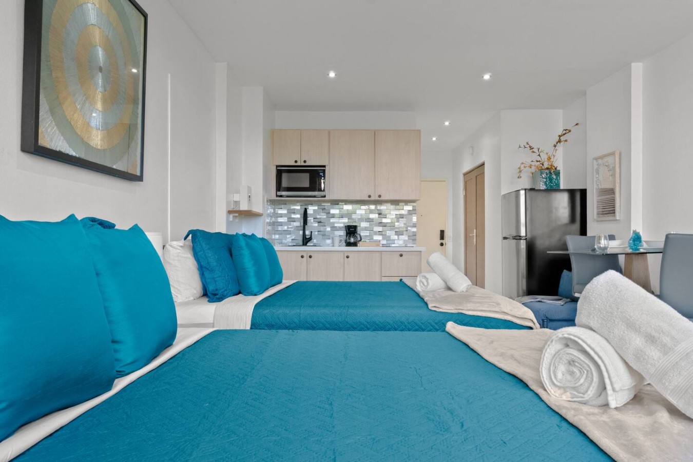 Blue bedroom with two blue pillows on a blue bedspread — T-Mobile District San Juan Next to Beach, San Juan