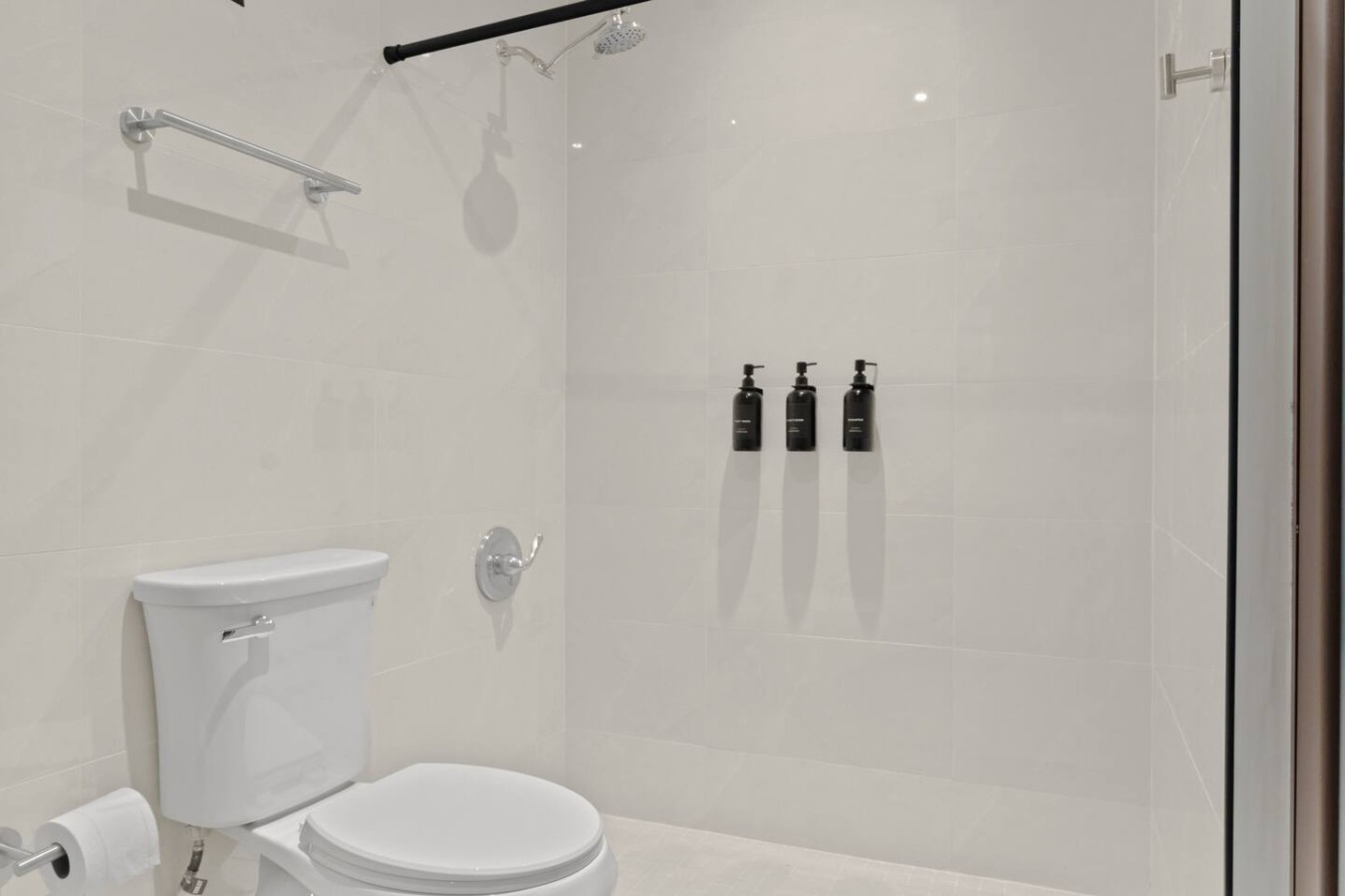 Bathroom with a walk-in shower and a toilet — T-Mobile District San Juan Next to Beach