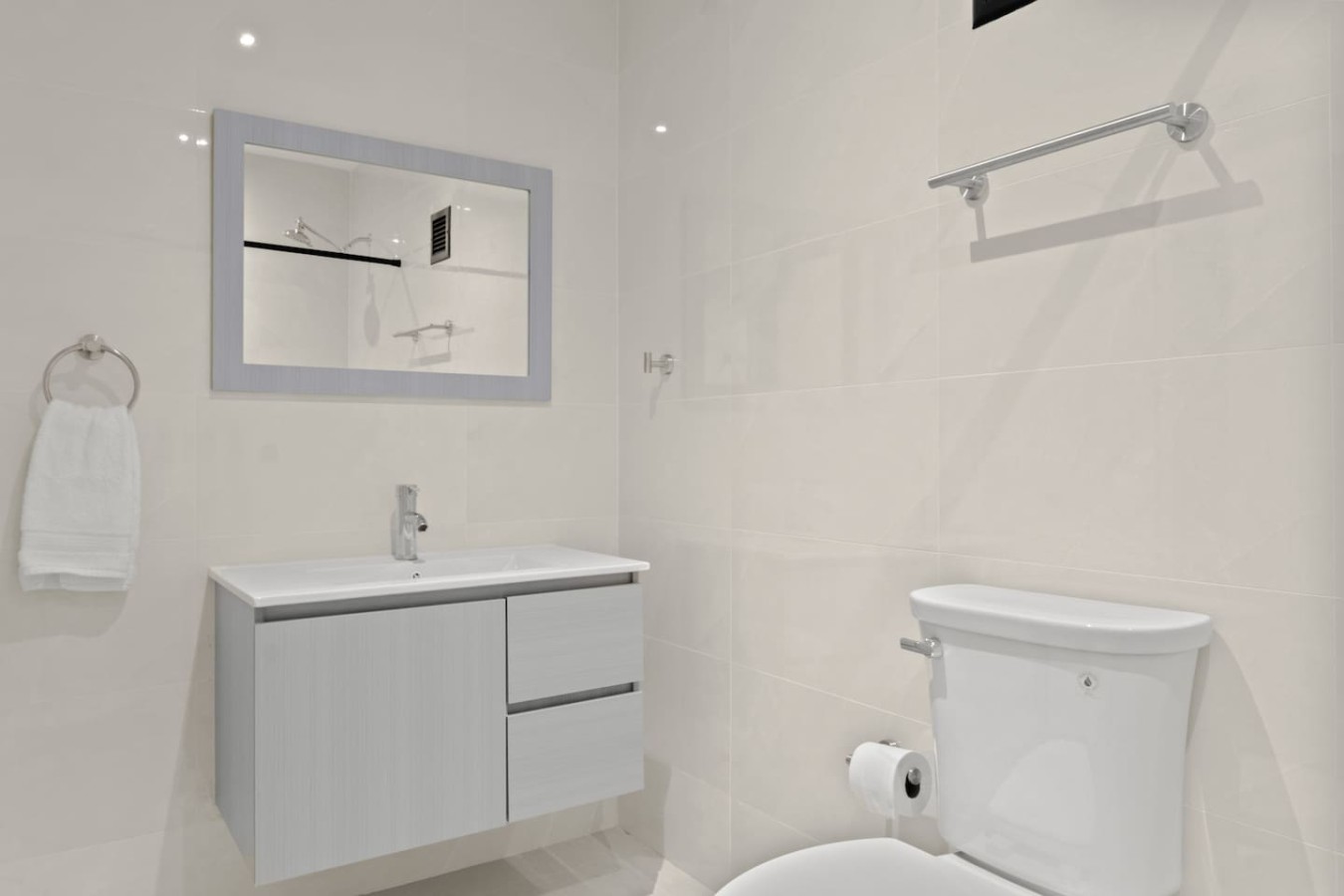 Bathroom with a white toilet and a sink — T-Mobile District San Juan Next to Beach