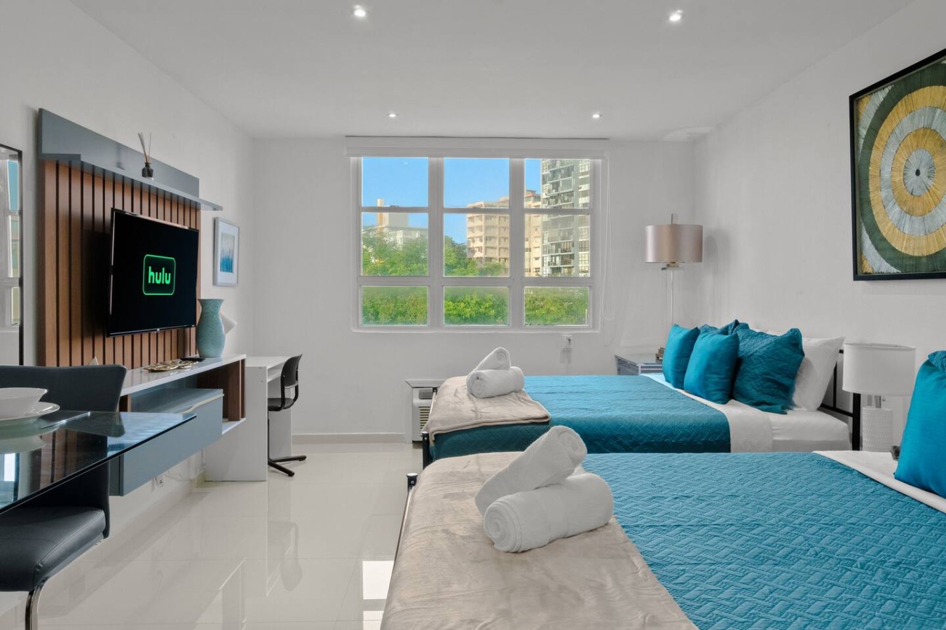 Bedroom with two beds and a television — T-Mobile District San Juan Next to Beach, San Juan