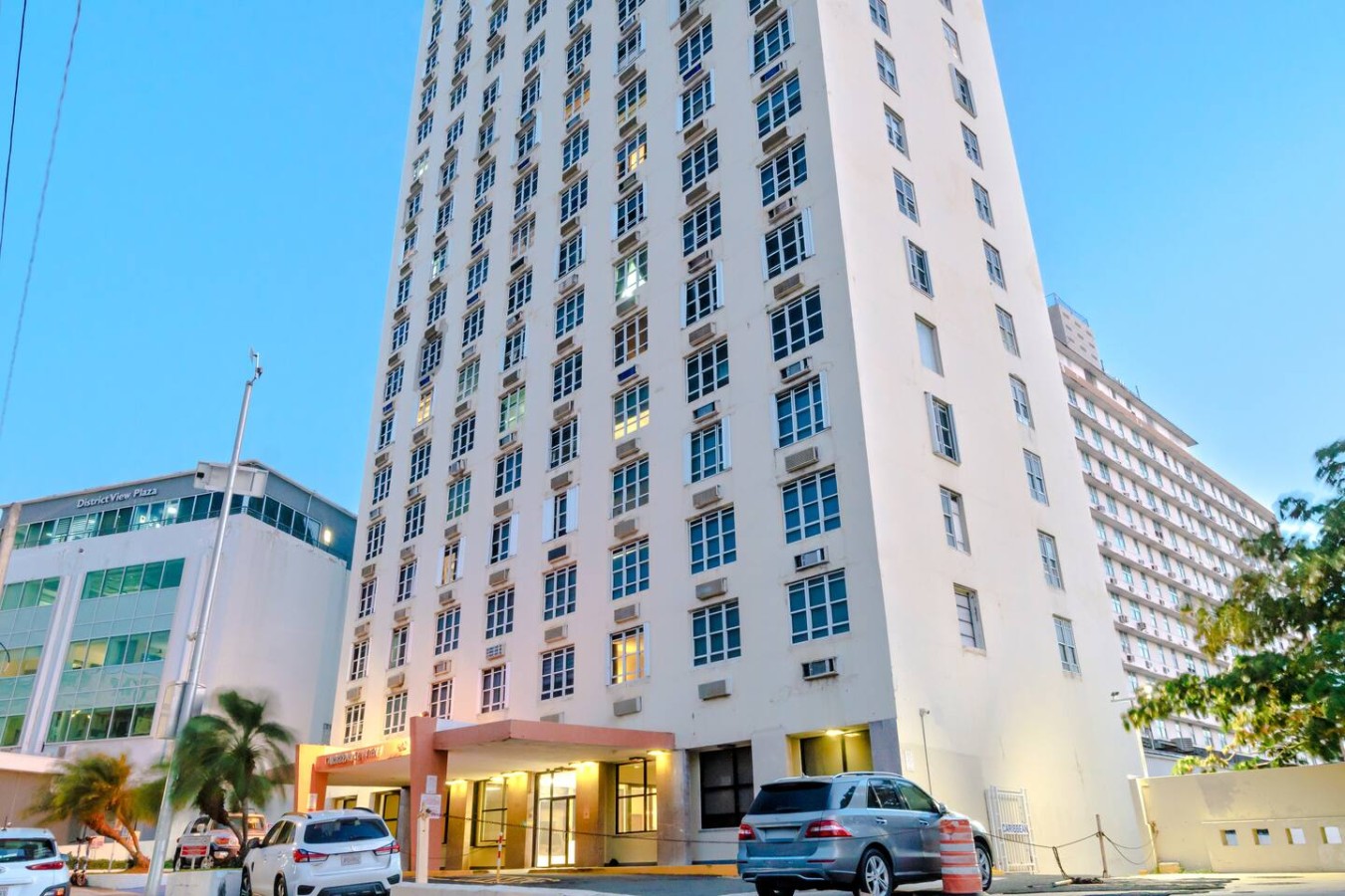 Building is white and has a balcony on the second floor — T-Mobile District San Juan Next to Beach, San Juan