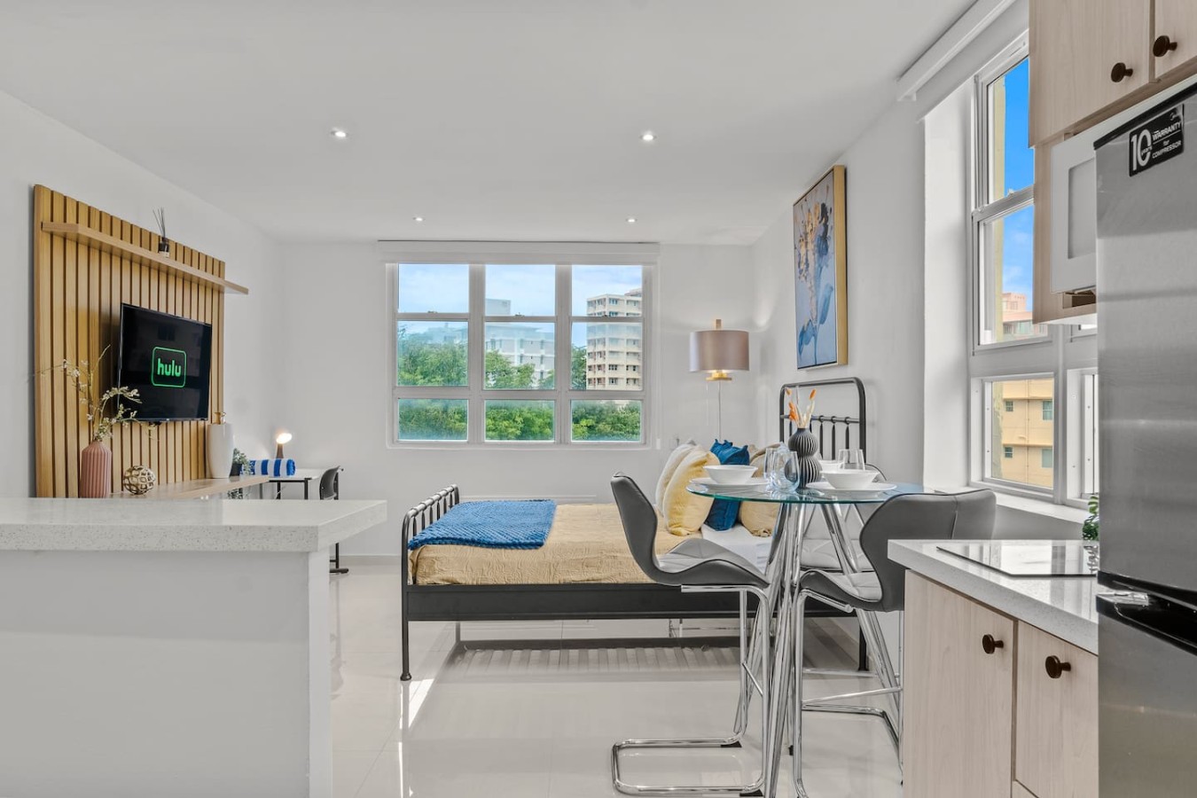 Bedroom with a bed and a window overlooking the city — Caribbean Sea View | Tmobile District Free Parking, San Juan