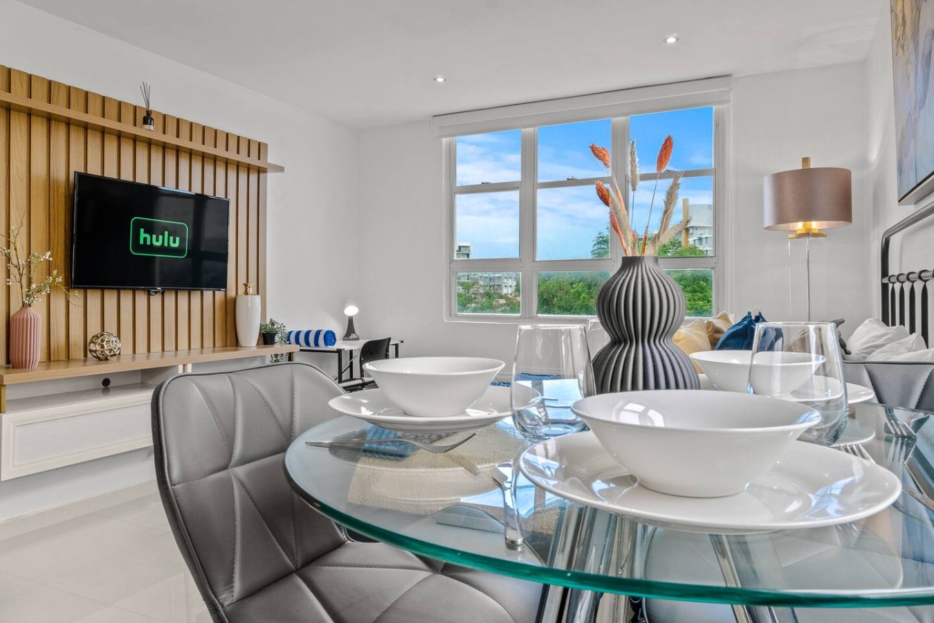 Glass dining table with a vase on it — Caribbean Sea View | Tmobile District Free Parking, San Juan