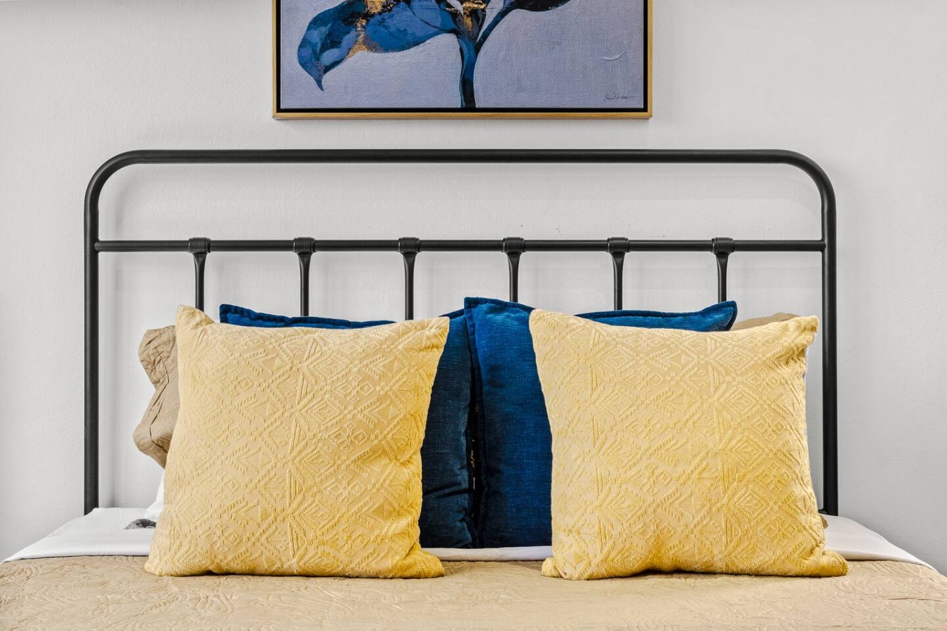 Bedroom with a yellow pillow and blue pillow — Caribbean Sea View | Tmobile District Free Parking, San Juan