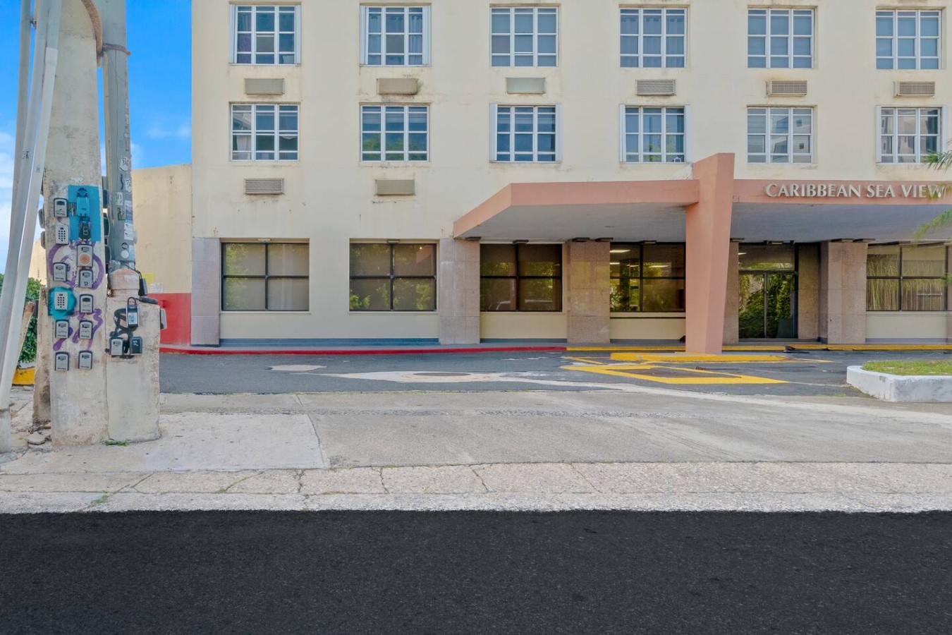 Building's entrance under a salmon-pink canopy — Caribbean Sea View | T-Mobile District Free Parking, San Juan