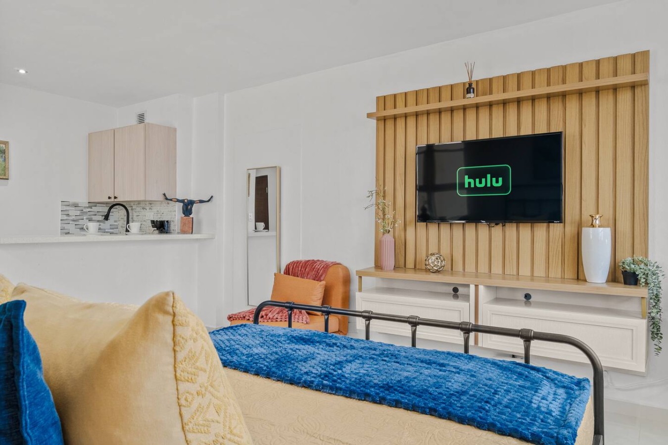 Bedroom with a blue bedspread and a yellow pillow — Caribbean Sea View | Tmobile District Free Parking, San Juan