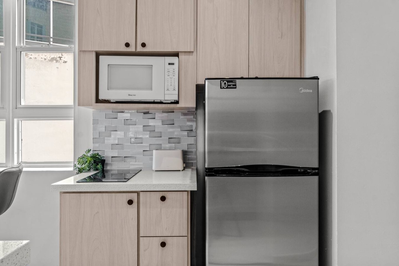 Kitchen with a microwave and a refrigerator — Caribbean Sea View | T-Mobile District Free Parking, San Juan