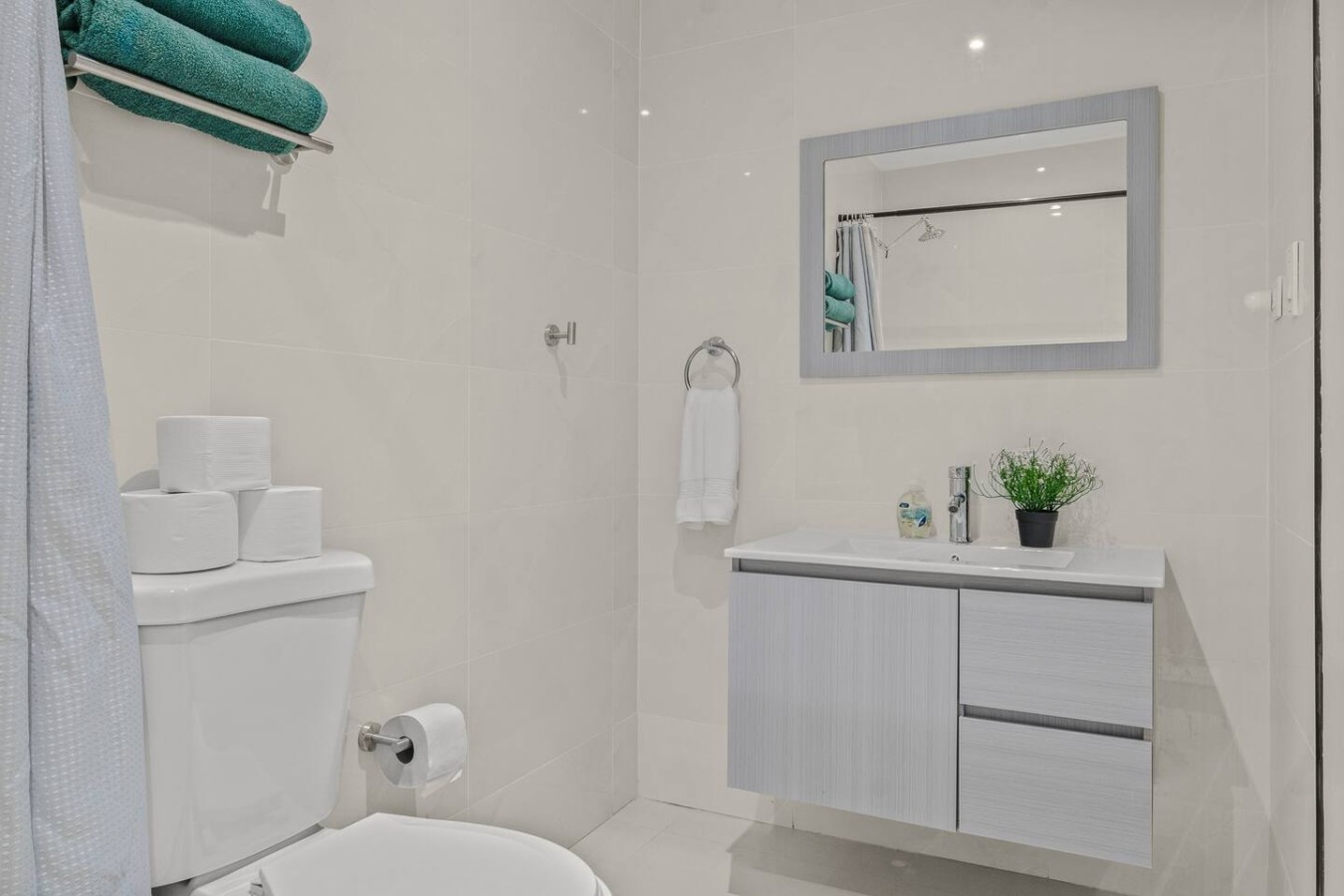 Bathroom with a vanity, a mirror and a toilet — Caribbean Sea View | T-Mobile District Free Parking, San Juan