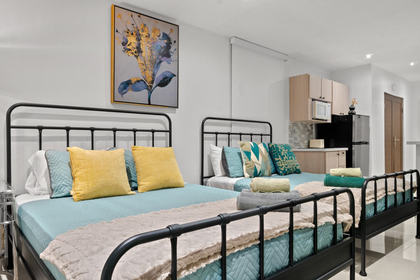 Bedroom with a black metal bed frame and blue sheets — Caribbean Sea View | Tmobile District Free Parking, San Juan