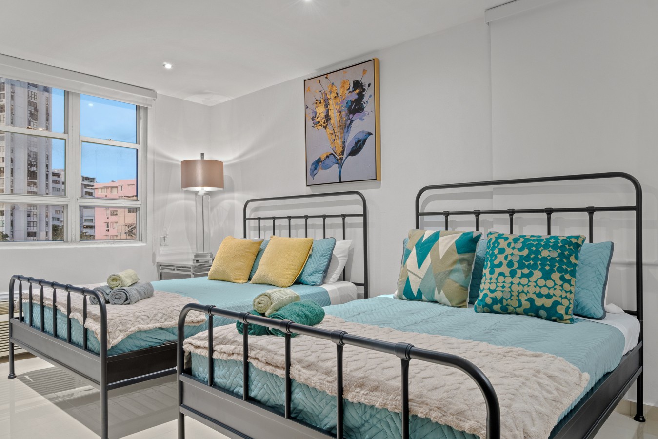 Two twin beds with blue sheets and pillows in a bedroom — Caribbean Sea View | Tmobile District Free Parking, San Juan