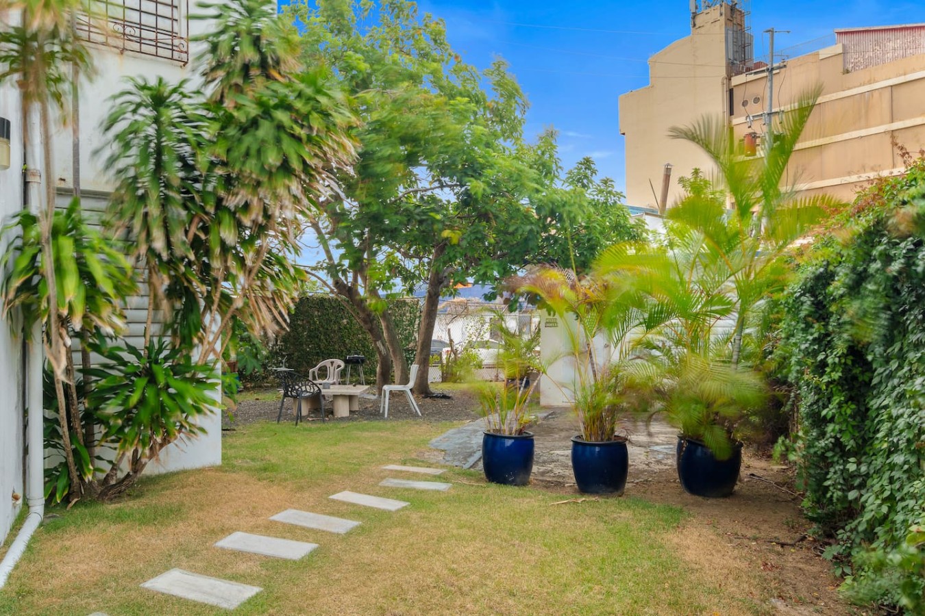 Patio with a table and chairs in front of a building — Private Patio 2BR Near Ocean Park Beach, Santurce