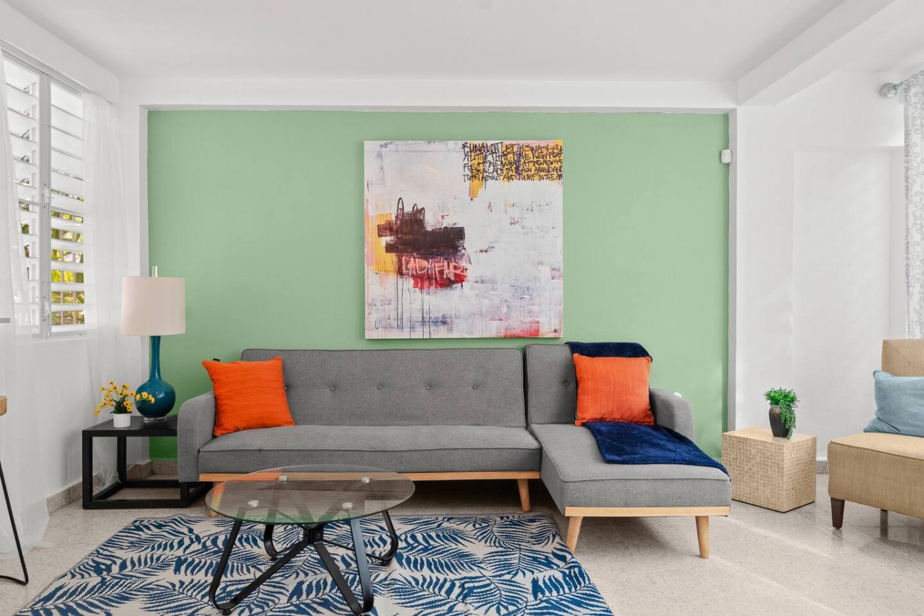 Gray couch with two orange pillows on it — Private Patio 2BR Near Ocean Park Beach, Santurce