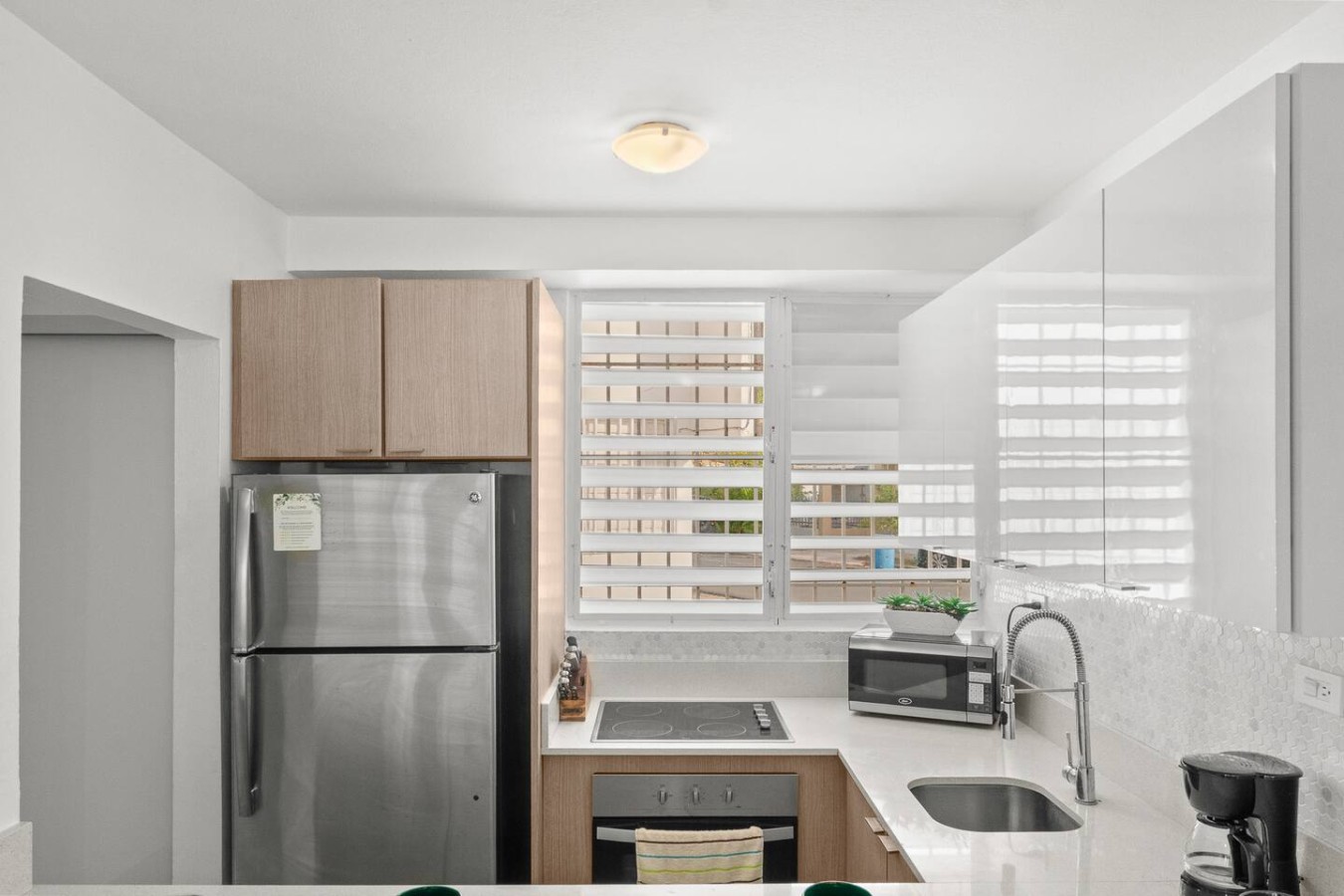 Kitchen with a refrigerator, stove, and sink — Private Patio 2BR Near Ocean Park Beach, Santurce