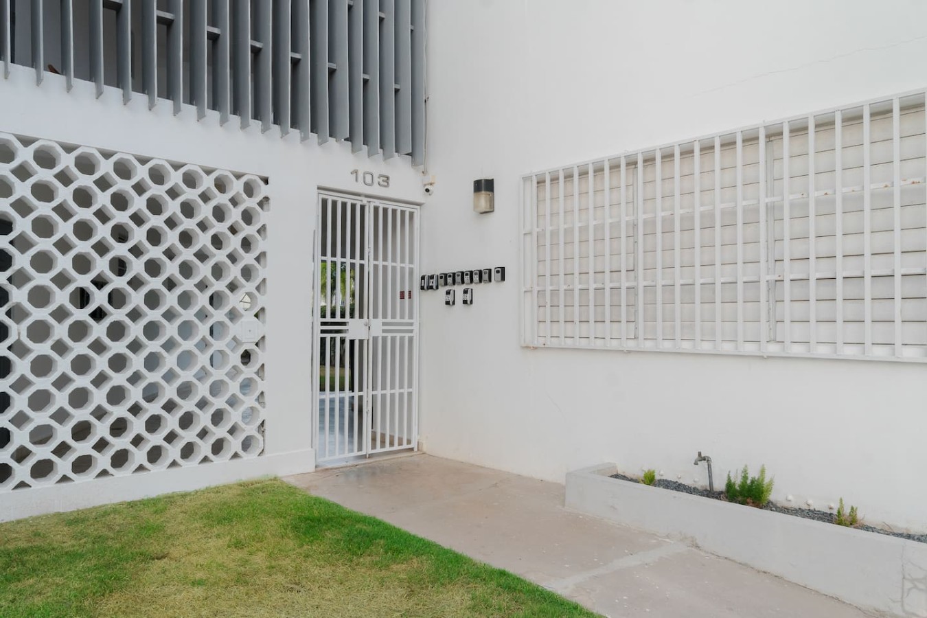 White building with a black door and a balcony — Private Patio 2BR Near Ocean Park Beach, Santurce