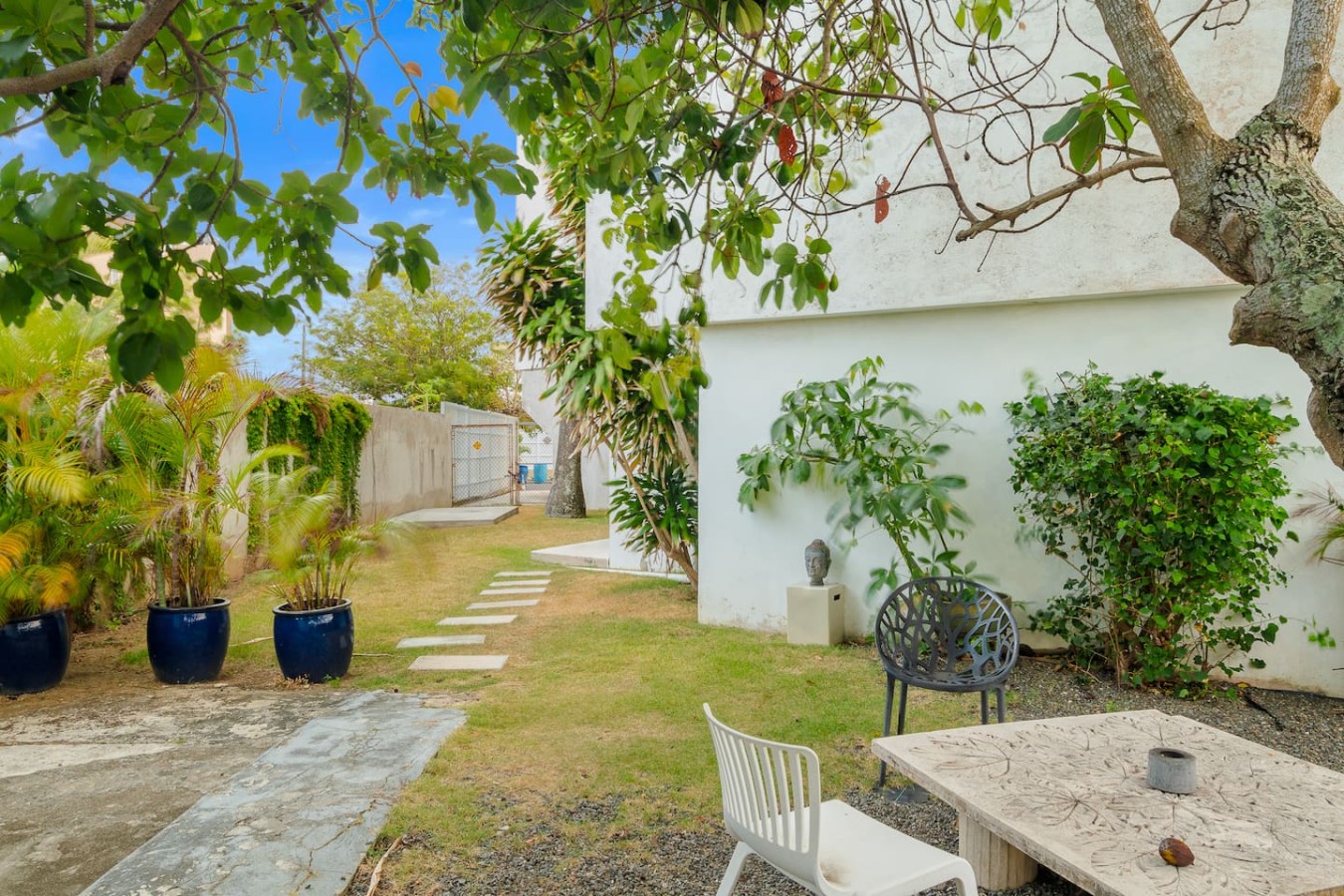 White house with a patio and a tree in front of it — Private Patio 2BR Near Ocean Park Beach, Santurce