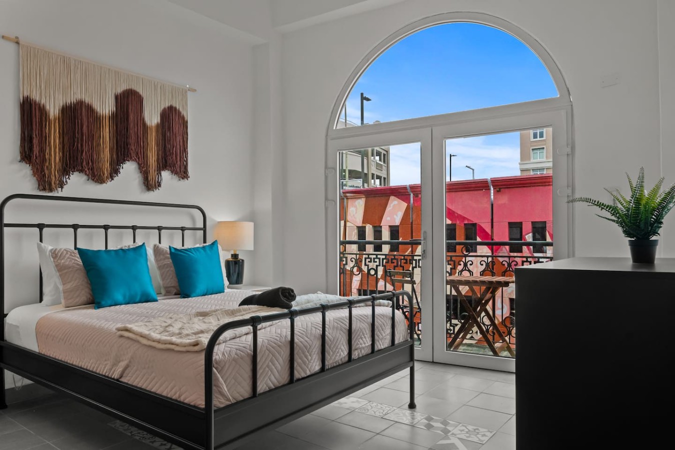 Black cat sitting on a bed in a bedroom — Grand Galleria — Old San Juan Private Patio, Old San Juan